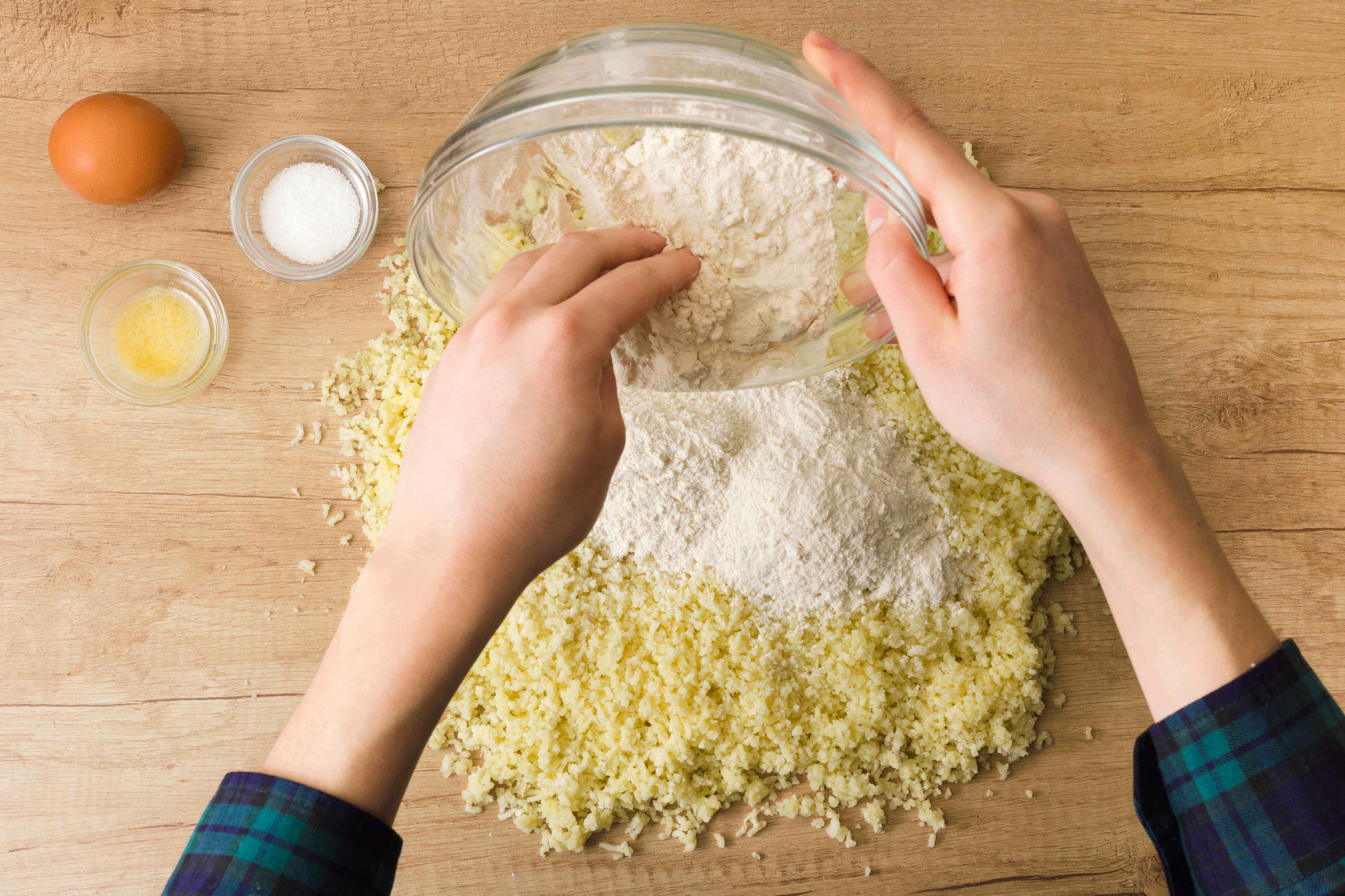 overhead-view-woman-preparing-italian-gnocchi-wooden-desk