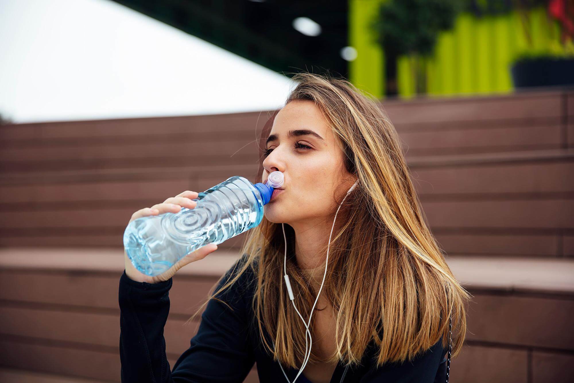 young-beautiful-women-resting-drinking-water-after-doing-exercises